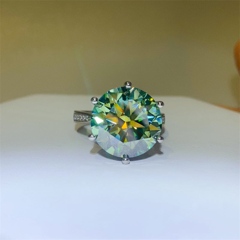 Stunning 10 carat Moissanite ring in 925 sterling silver with vibrant green and blue sparkle, captured on a soft background.