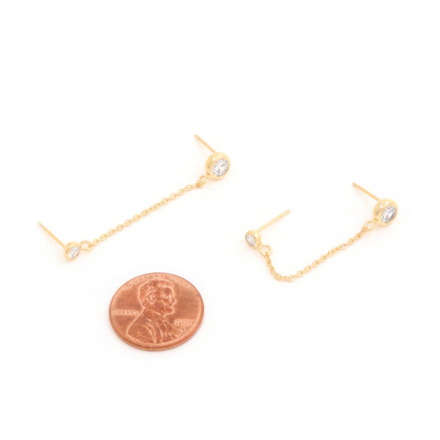 14K gold dipped chain earrings with cubic zirconia accent next to a penny for size reference.