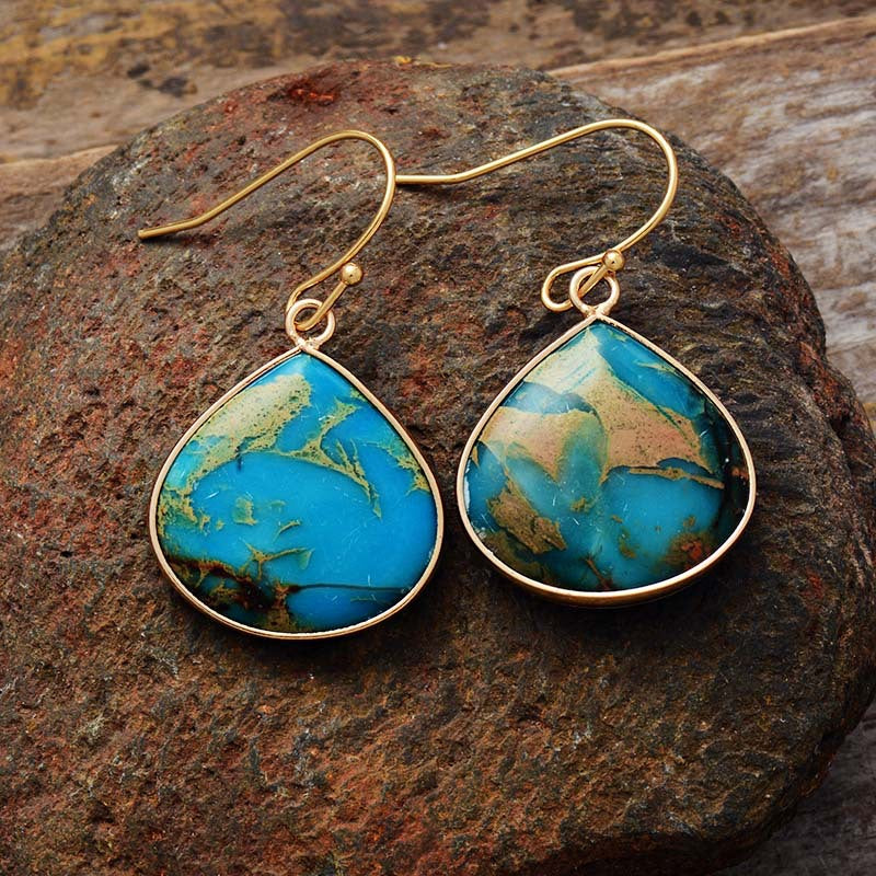 18K gold-plated natural stone earrings featuring blue and gold swirled stones in a teardrop design.
